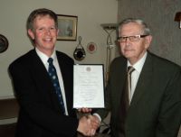 Bill Chandler recieves his 40-year scroll